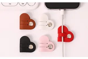 Close-up of heart-shaped PU leather cable organizers in various colors with snap button