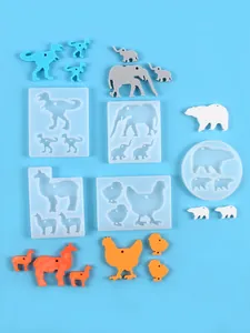 Detailed view of various animal-shaped silicone molds with colorful resin casts for DIY