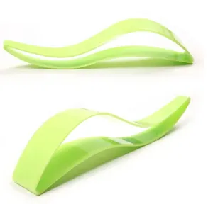 Close-up view of the wave-shaped green plastic cake cutter and server for triangular slices