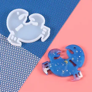 Detailed view of Cancer zodiac silicone resin mold with a finished sparkling blue pendant