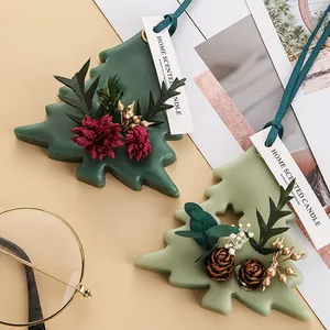 Detailed view of Christmas tree shaped scented wax ornaments with decorative dried flowers
