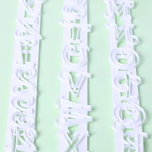 Close-up of white plastic alphabet letter cookie molds for DIY cake decorating