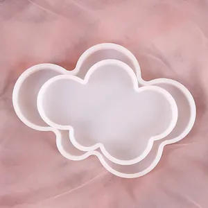 Top-down view of two different sized cloud-shaped silicone molds for DIY epoxy resin coasters