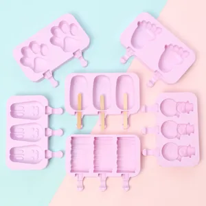 Collection of pink silicone popsicle molds in various shapes like paw, rabbit and snowman