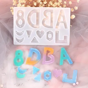 Macro view showing the translucent silicone jewelry mold and colorful resin alphabet pendants