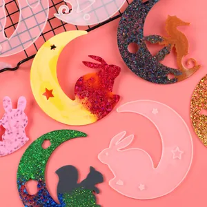 Detailed view of moon and bunny silicone molds for resin jewelry making.