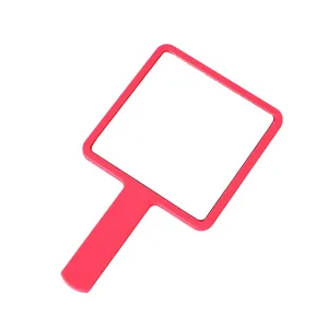 Minimalist portable pink square handheld makeup mirror for daily beauty and grooming.