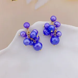 Close-up macro shot of elegant purple grape-shaped freshwater pearl cluster stud earrings