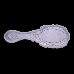 Detail view of vintage-style silicone mold for resin mirror and comb DIY crafts.