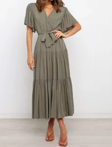 Front detail view of an olive green V-neck bohemian maxi dress with ruffle sleeves.