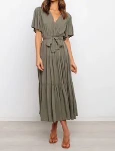 Detailed view of women's bohemian V-neck maxi dress with tiered ruffle hem and tie waist