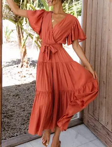 Bohemian rust-red V-neck maxi dress featuring ruffled sleeves and a tiered skirt design.