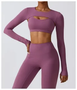 Front view of a mauve long-sleeved cutout yoga shrug paired with a matching sports bra