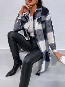 Woman wearing a stylish blue and white plaid longline shirt jacket with black leather pants.