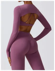 Back view of a purple long-sleeved yoga shrug and matching high-waisted leggings set