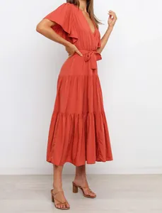 Bohemian V-neck tiered maxi dress with ruffle sleeves and a cinched waist tie.