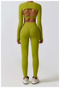 Back view of woman in lime green long sleeve yoga shrug and high waisted leggings