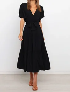 Front view of a chic black V-neck bohemian tiered midi dress featuring ruffle short sleeves.