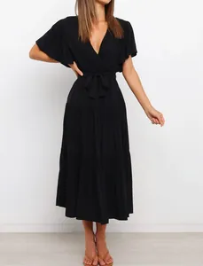 Front view of a black V-neck bohemian maxi dress with ruffle sleeves and tie waist