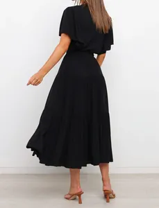 Back view of an elegant black tiered maxi dress with flutter sleeves for summer style