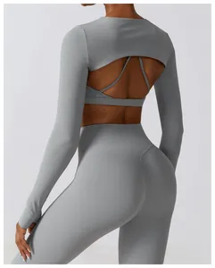 Back view of a minimalist grey long sleeve yoga shrug with a breathable cut-out design