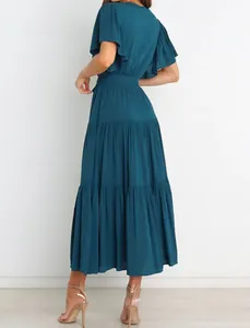 Back view of teal bohemian tiered maxi dress with ruffled sleeves and pleated skirt