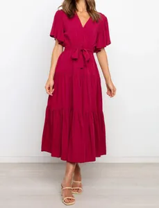 Detail view of a wine red V-neck bohemian maxi dress with ruffled sleeves and waist tie.