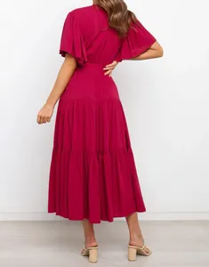 Back view of a bohemian magenta tiered maxi dress with flutter sleeves and cinched waistline