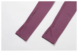 Close-up of integrated thumb holes on a purple long-sleeved sports shrug for yoga.