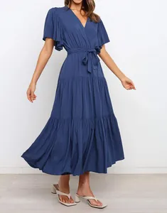 Elegant blue V-neck Bohemian long dress with ruffle short sleeves and waist tie detail.