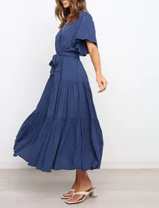 Side view of navy blue V-neck bohemian dress with flutter sleeves and tiered skirt