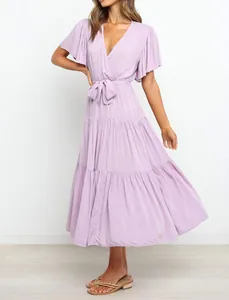 Elegant lavender boho maxi dress with V-neck, ruffled sleeves, and tiered skirt detail.