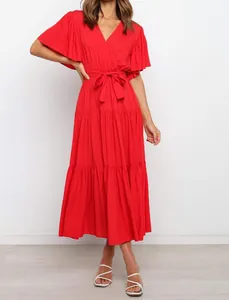Full view of elegant red V-neck maxi dress with ruffle sleeves and belted waist.