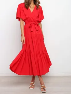 Elegant red V-neck Bohemian maxi dress featuring ruffle sleeves and a waist tie belt