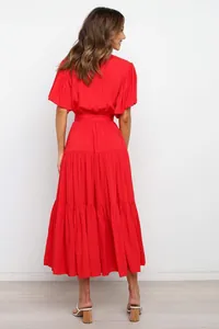 Back view of a red tiered maxi dress with bohemian style and short flutter sleeves