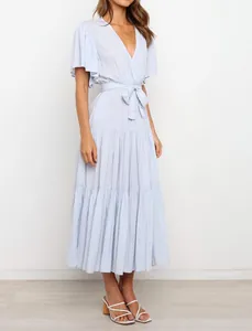 Side view of a light blue V-neck ruffled midi dress with a belted waist