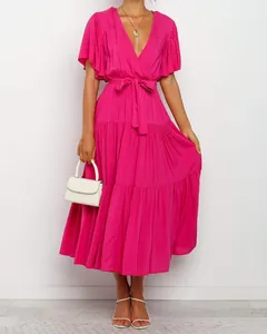 Bohemian fuchsia V-neck maxi dress featuring ruffled sleeves and a tiered skirt design