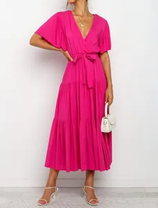 Detail view of a magenta V-neck Bohemian maxi dress with ruffles and a waist tie.