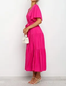 Side view of a hot pink V-neck bohemian maxi dress with tiered ruffles and butterfly sleeves