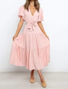 Elegant light pink bohemian V-neck dress with ruffled sleeves and tiered skirt detail