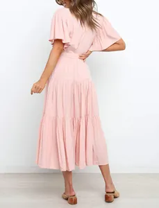 Back view of a pink Bohemian maxi dress featuring ruffled sleeves and a tiered skirt design