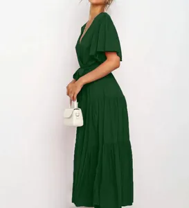 Close-up detail of dark green Bohemian maxi dress with V-neck and tiered ruffle sleeves