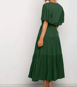 Elegant back view of dark green bohemian maxi dress with ruffle sleeves and tiered ruffled skirt