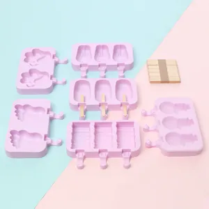 Variety of pink silicone ice pop molds in cute shapes including wooden popsicle sticks