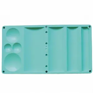 Detail view of teal plastic fondant flower drying tray with multiple compartments