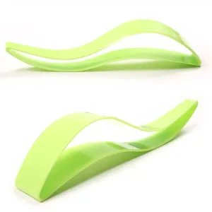 Macro view of a lime green wave-shaped cake slicer tool for clean cake serving