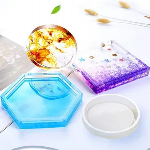 Assorted geometric silicone molds and finished resin coasters in vibrant colors.
