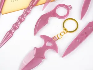 Detail view of pink pearlescent resin crafts shaped like magic wands and daggers