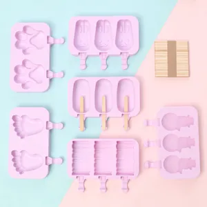 Collection of pink silicone popsicle molds in various shapes with wooden sticks set.