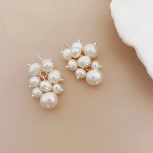 Detailed macro shot of elegant grape-shaped freshwater pearl cluster stud earrings.